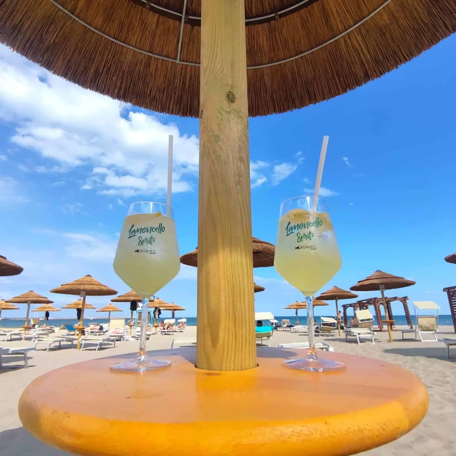 Cocktail drinks served under beach umbrella Sicily