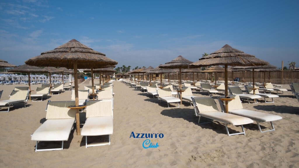 Beach umbrellas and sunbeds setup across sandy coastline Sicily